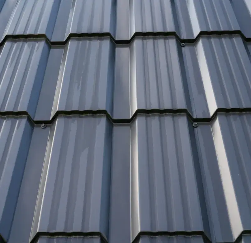 Close-up of a dark gray metal tile roof with a modern design.